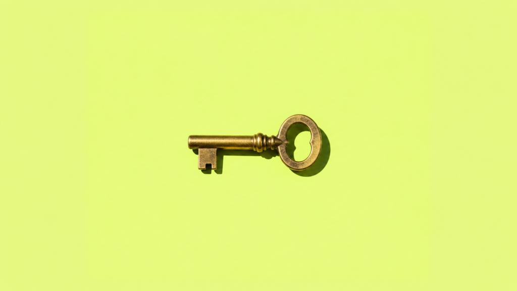A small brass key on a lime green background