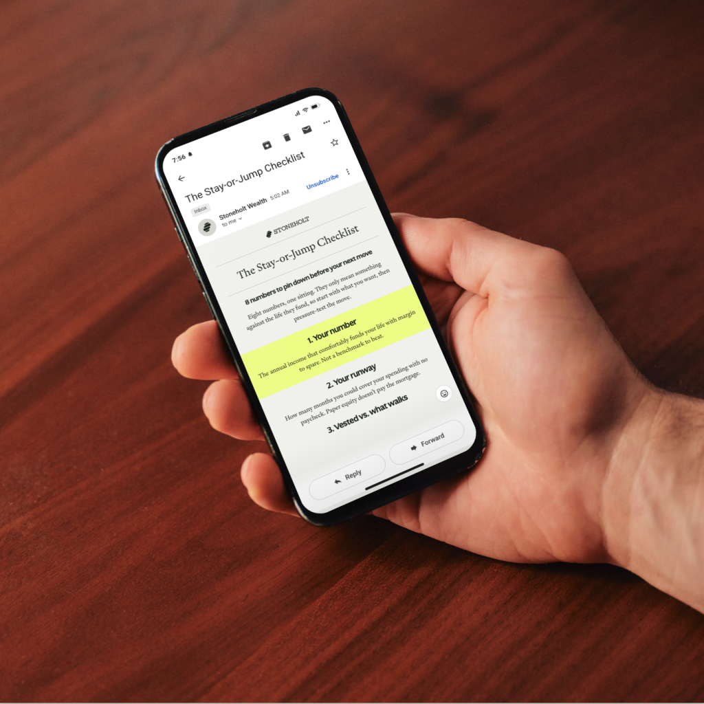 Hand holding a phone showing a Stoneholt Wealth article